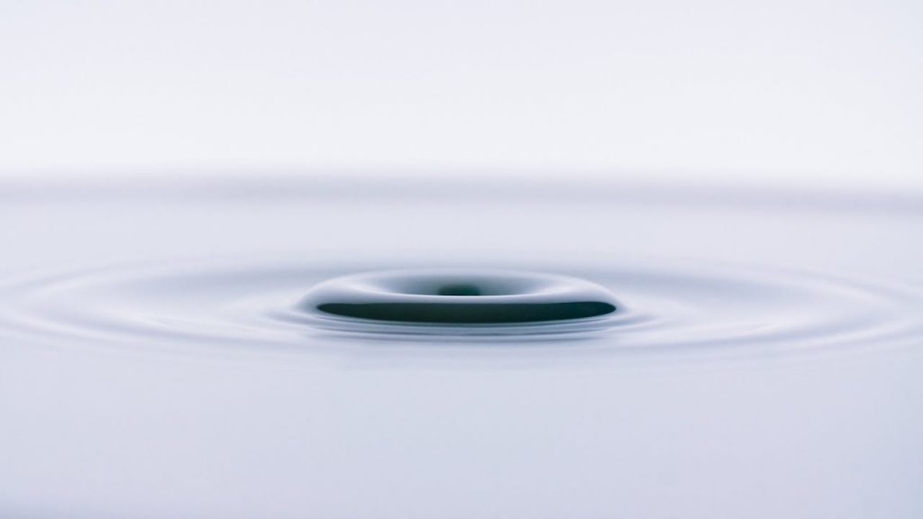 Close-up of a smooth water ripple creating an abstract, minimalist effect.
